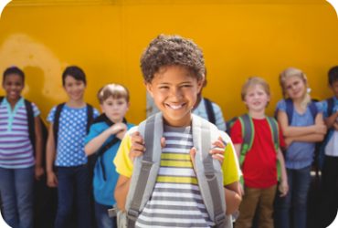 child smiling child with backpack